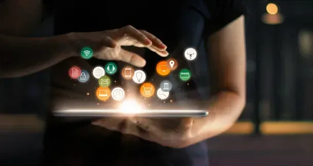 Essential Website Maintenance & Security Updates Hands holding a glowing tablet surrounded by digital icons representing website maintenance, security lock, and page speed optimization.